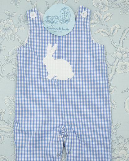 Blue checkered overalls with a bunny design on a floral background